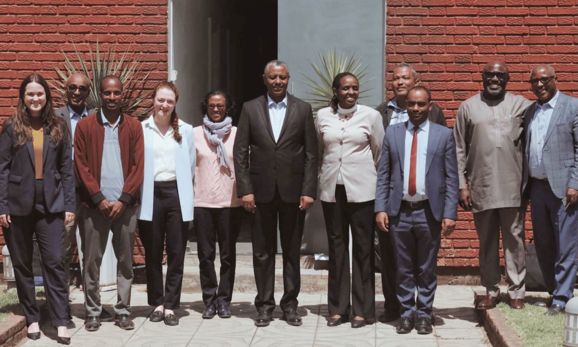 12 people of different nationalities pose for a photo